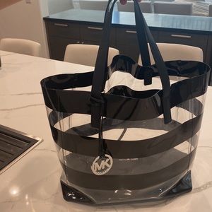 Michael Kors waterproof beach bag. Includes matching wallet with strap